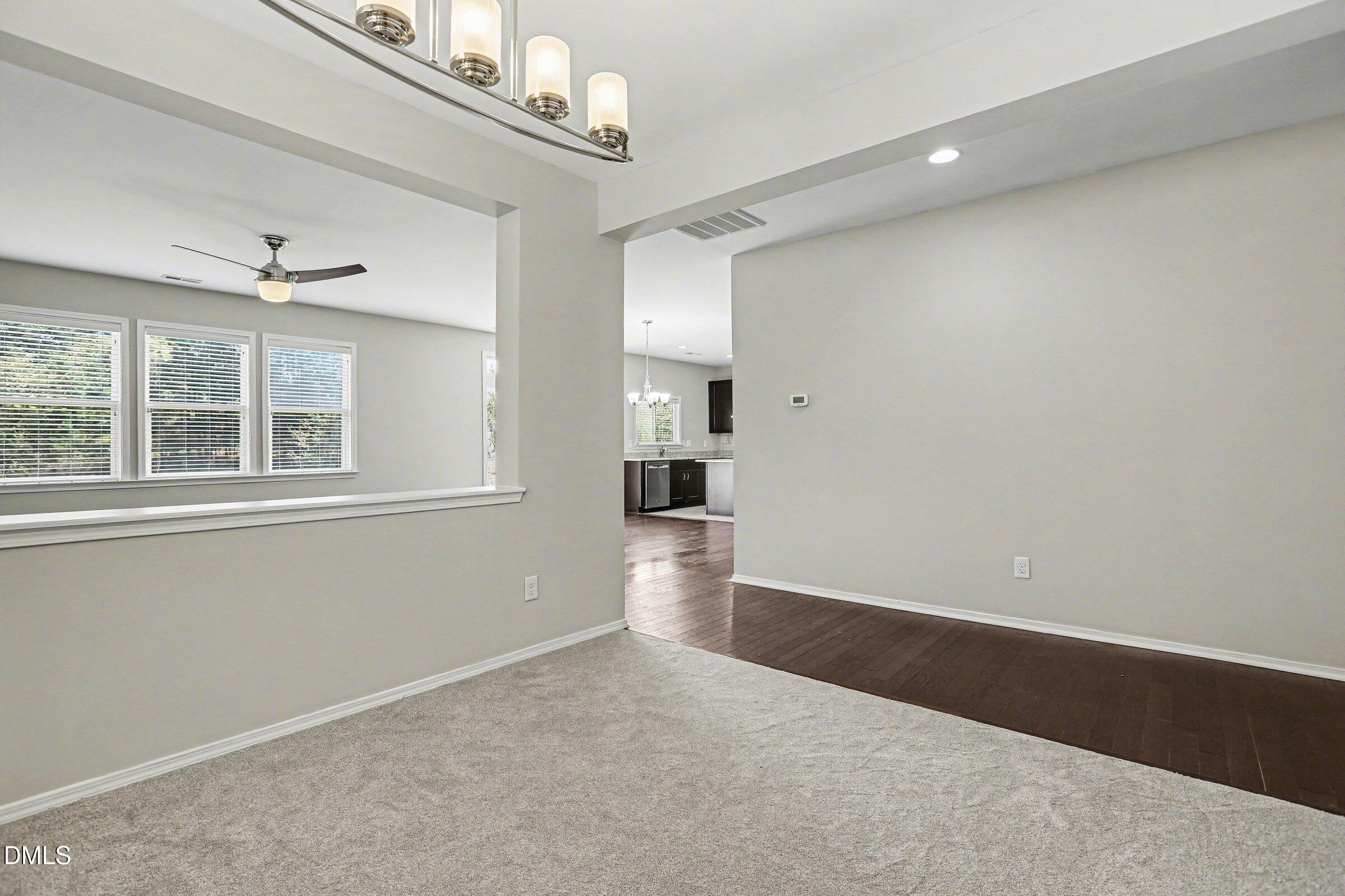 132 Daneborg Road Durham, NC 27703 - Photo 15 of 37 a view of empty room with wooden floor and windows