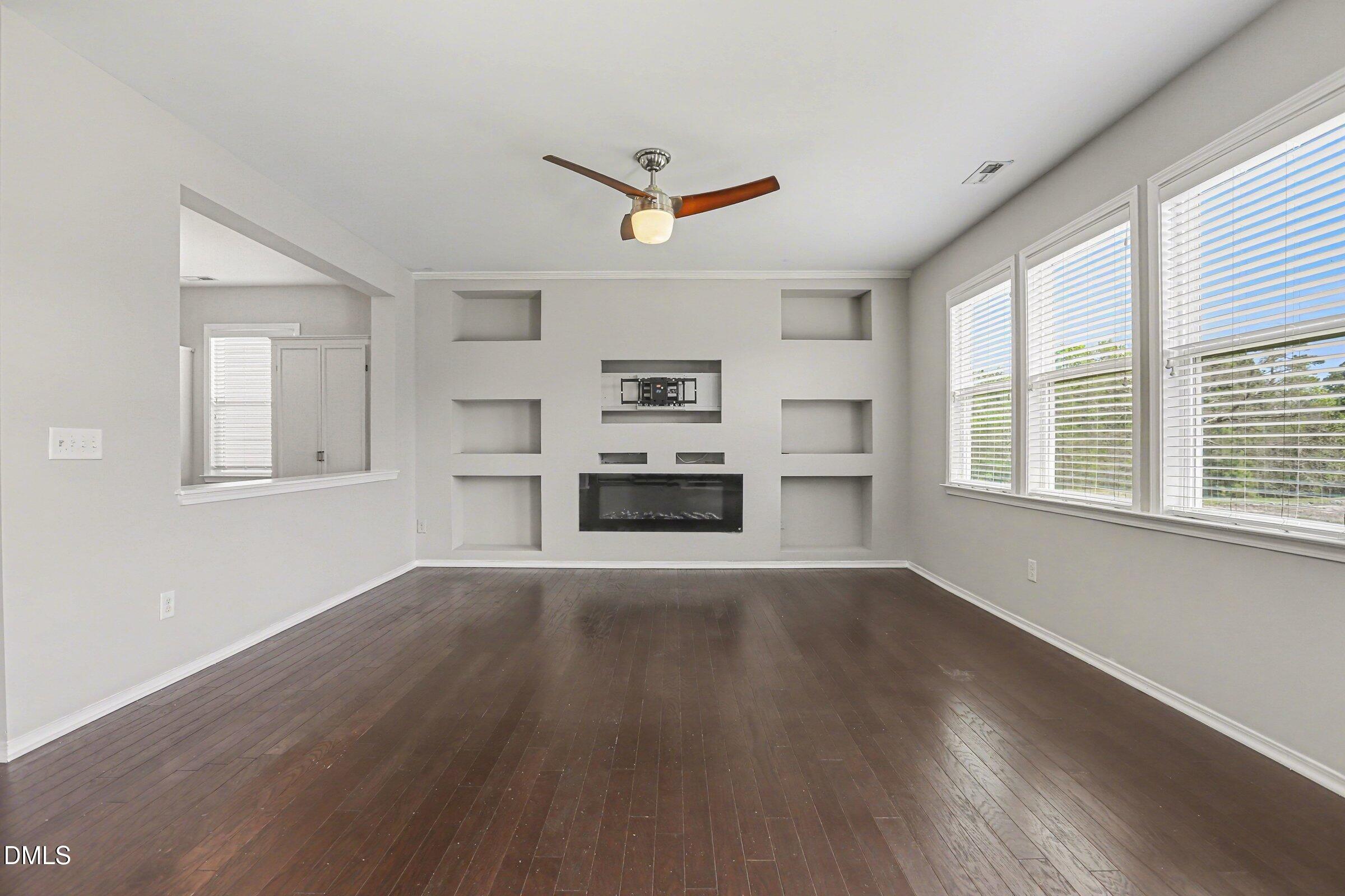 132 Daneborg Road Durham, NC 27703 - Photo 17 of 37 a view of an empty room with a window and wooden floor