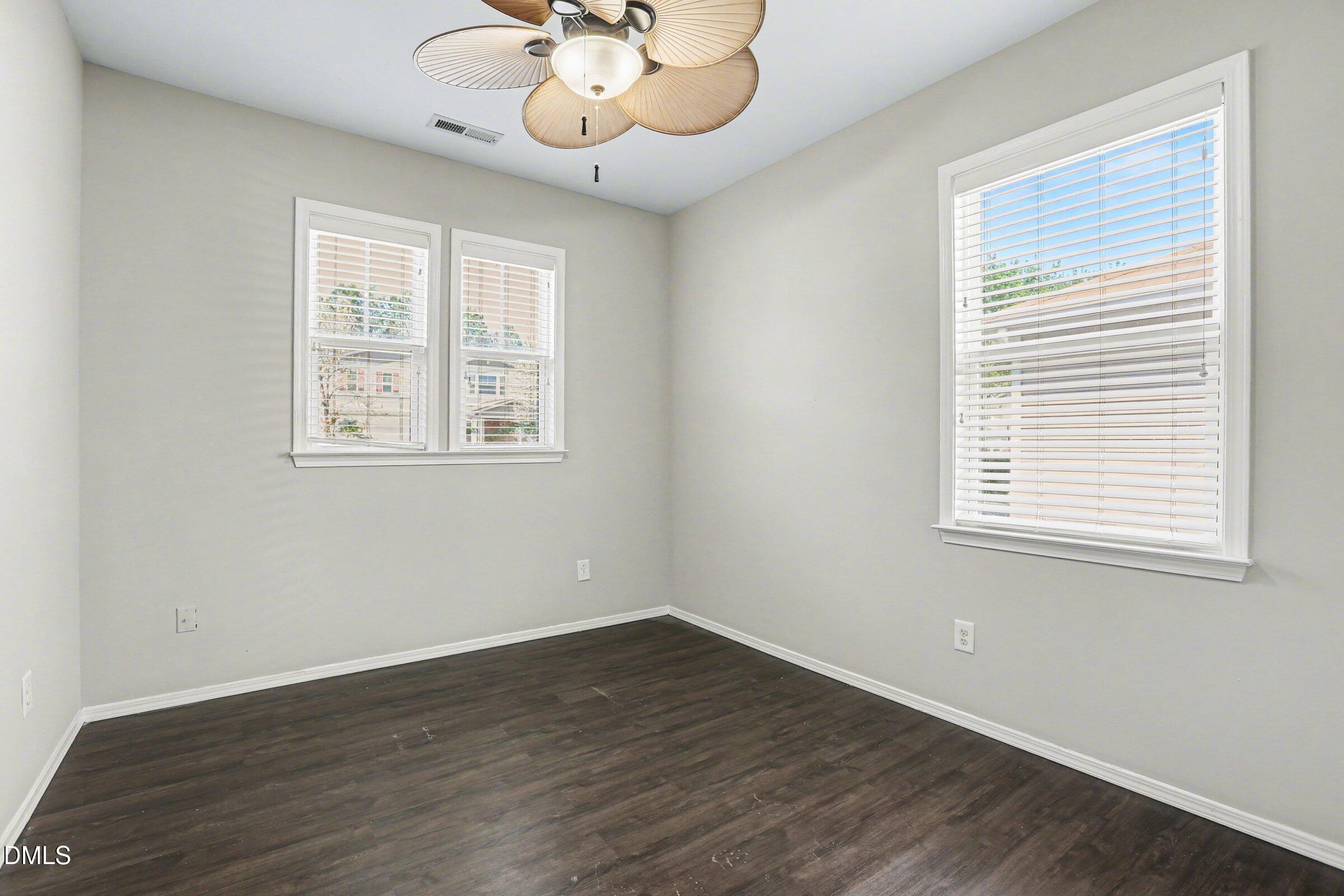 132 Daneborg Road Durham, NC 27703 - Photo 22 of 37 a view of an empty room with wooden floor and a window