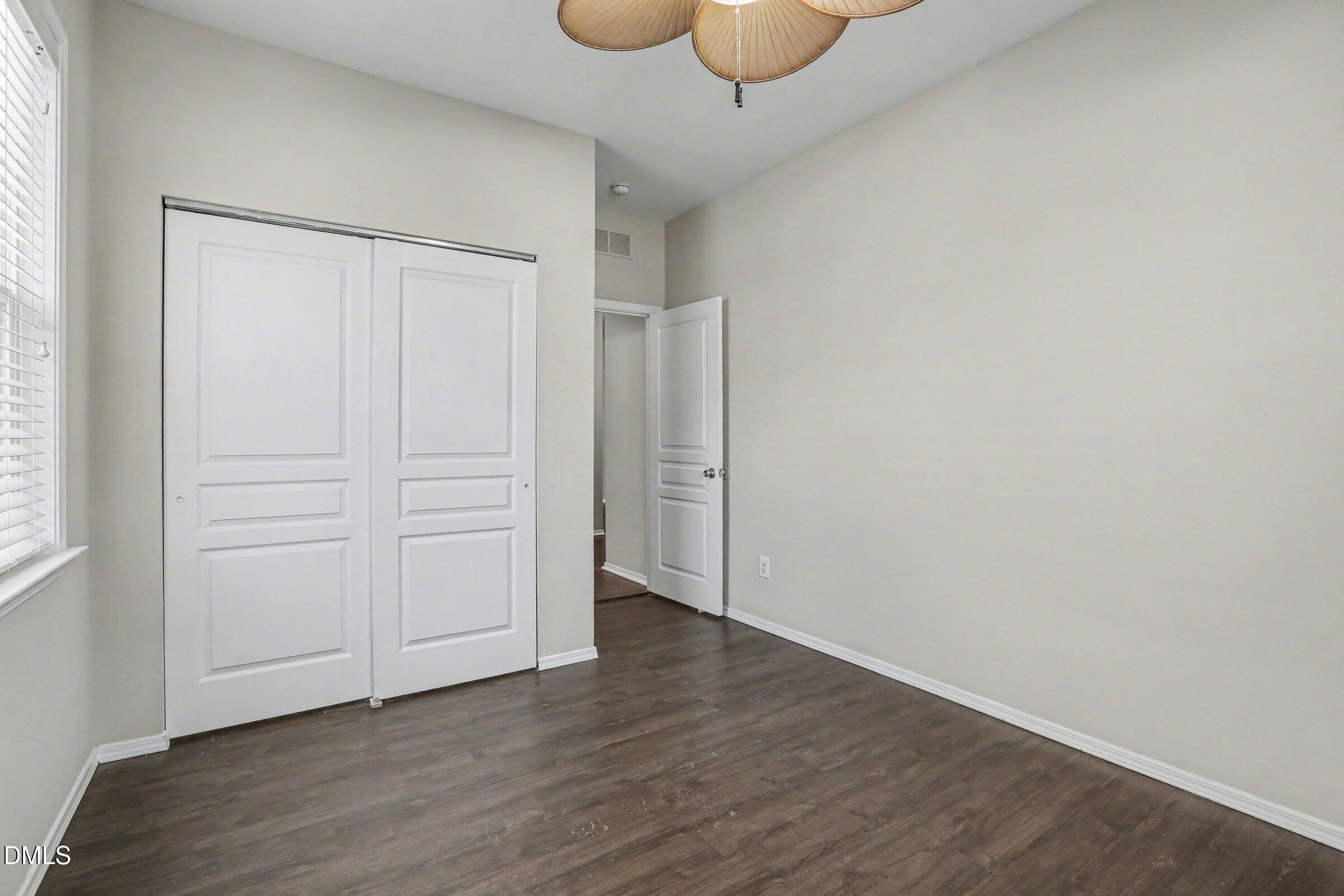 132 Daneborg Road Durham, NC 27703 - Photo 23 of 37 an empty room with wooden floor and cabinet