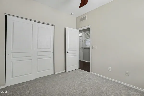 an empty room with closet area