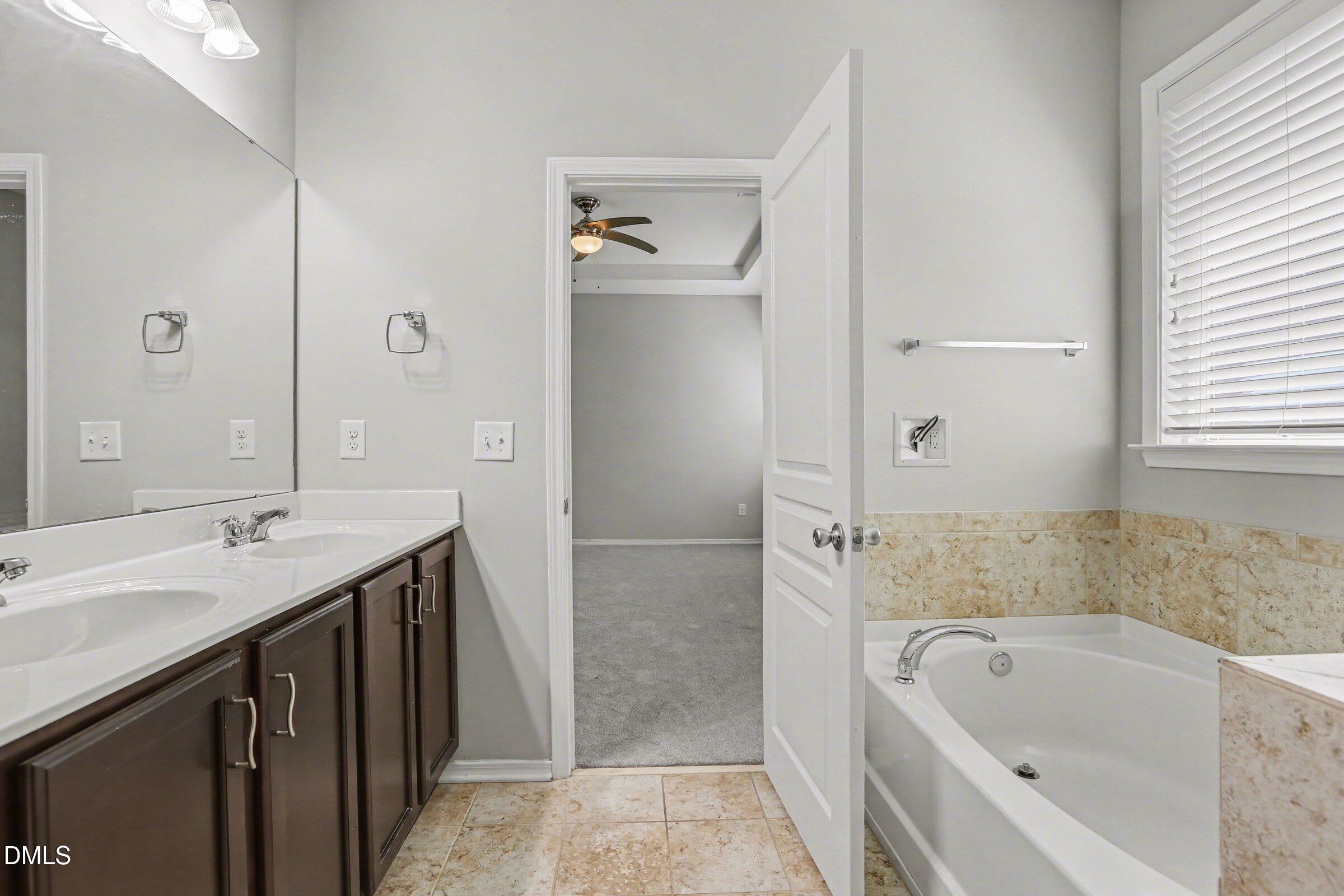 132 Daneborg Road Durham, NC 27703 - Photo 28 of 37 a bathroom with a tub sink and mirror