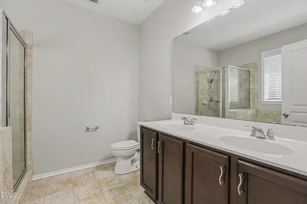 a bathroom with a sink a toilet a mirror and vanity