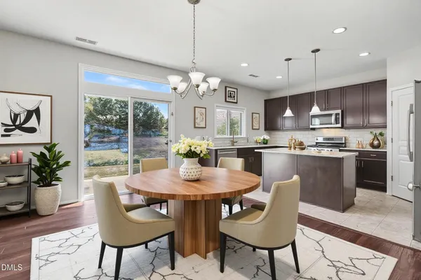 a view of a dining room with furniture window and wooden floor