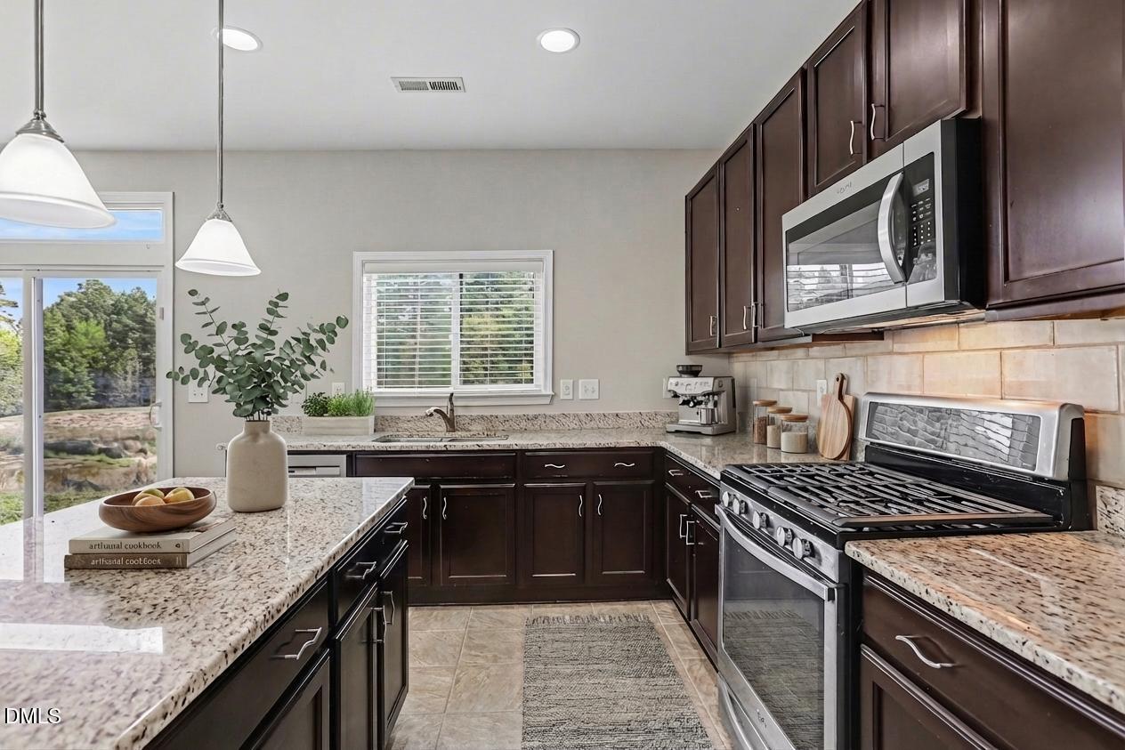 132 Daneborg Road Durham, NC 27703 - Photo 6 of 37 a kitchen with a sink stove and microwave