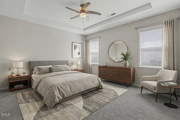 a bedroom with a bed a couches and a chandelier