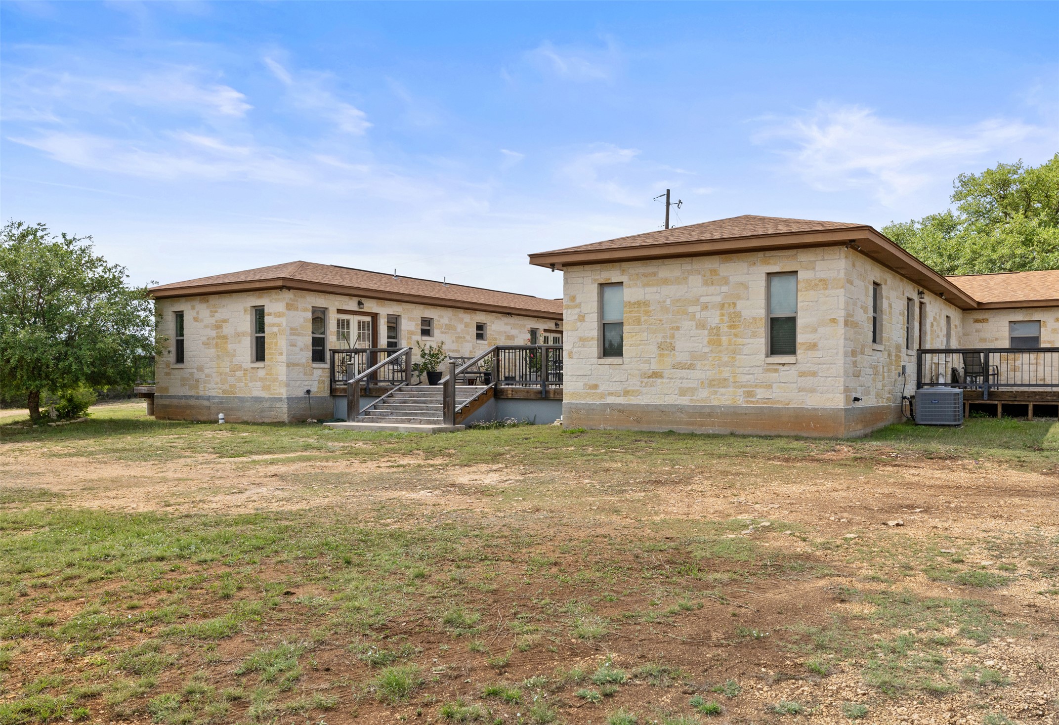 2966 Rm 165 Dripping Springs Dripping Springs, TX 78620 - Photo 22 of 23 Stone veneer exterior with multiple windows