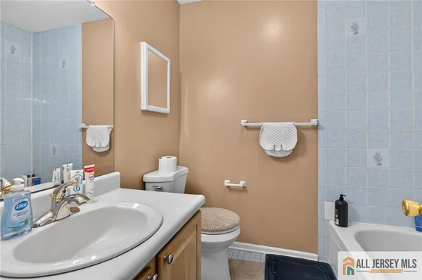 a bathroom with a sink a toilet and mirror