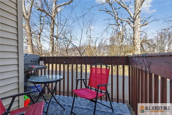 a view of a chairs and table in the balcony