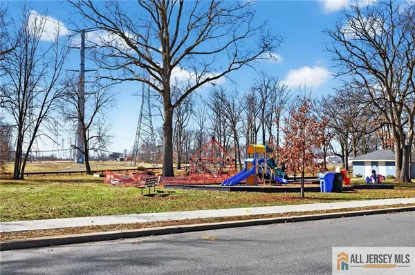 a view of a swimming pool with a lawn chairs under an umbrella