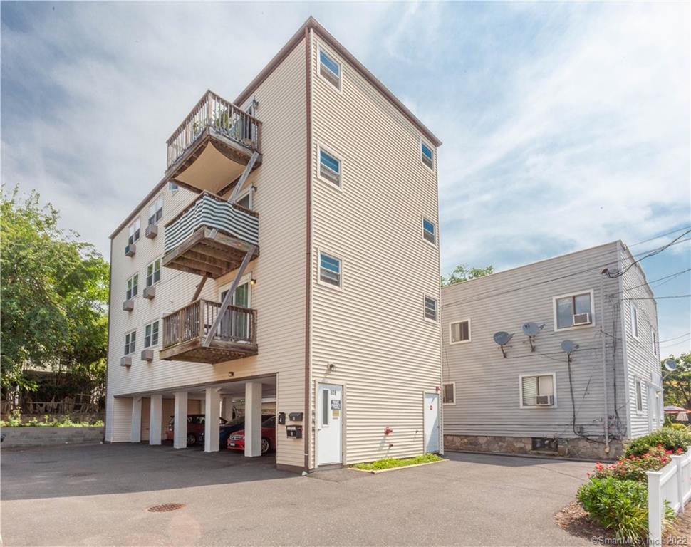 808 Cove Road, Unit 2 Stamford, CT 06902 - Photo 1 of 1 a front view of a building with a street