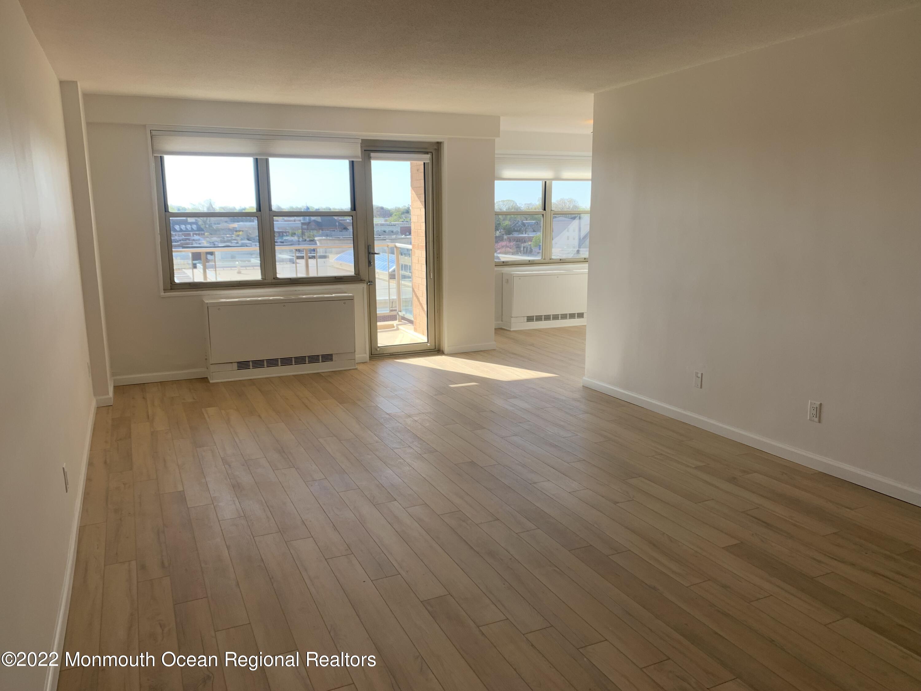 28 Riverside Avenue, Unit 6C Red Bank, NJ 07701 - Photo 12 of 26 an empty room with wooden floor and windows