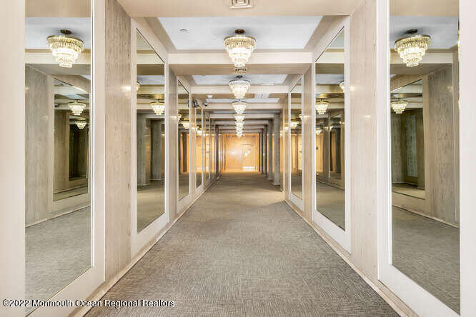 28 Riverside Avenue, Unit 6C Red Bank, NJ 07701 - Photo 20 of 26 a view of a hallway with wooden shelves