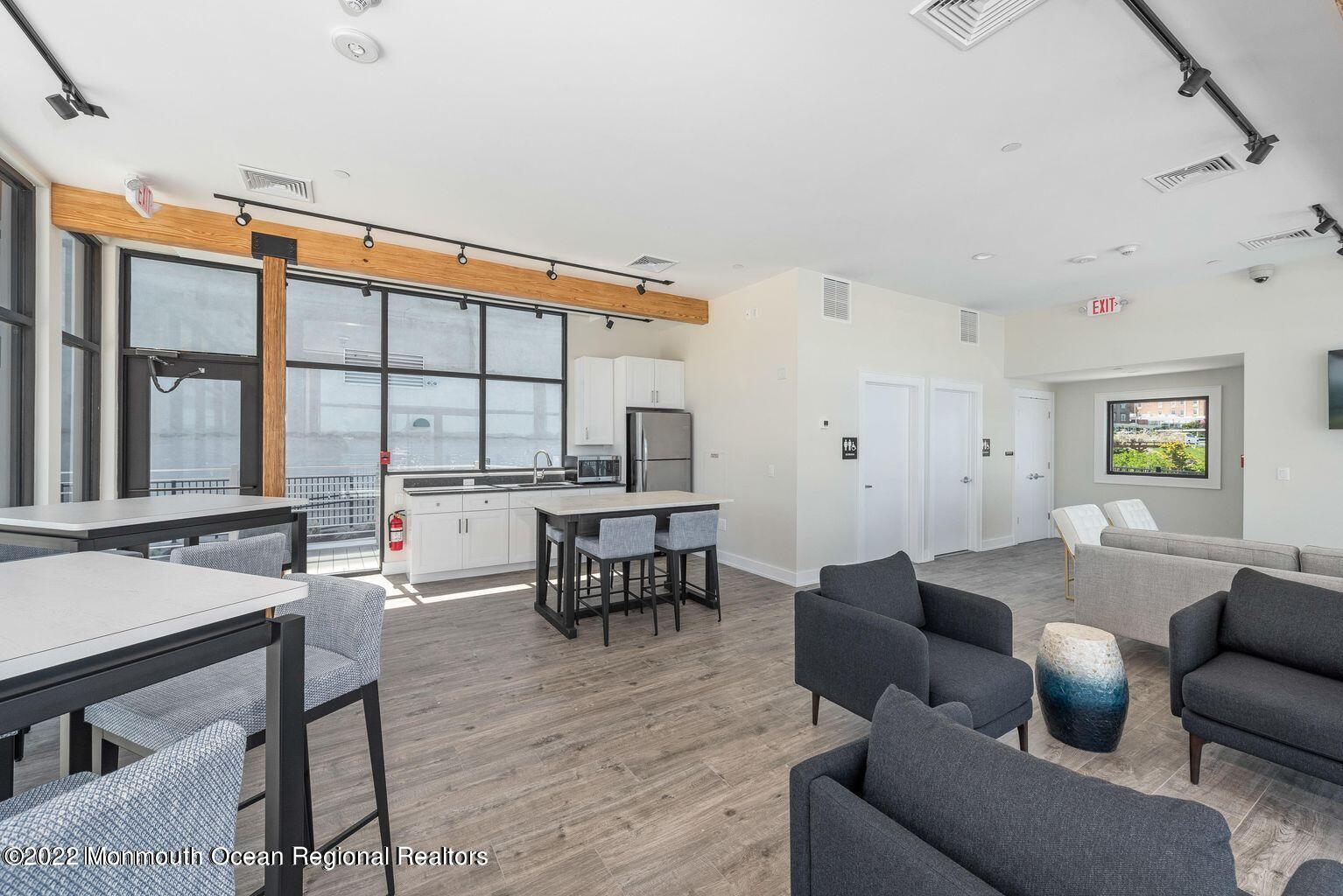 28 Riverside Avenue, Unit 6C Red Bank, NJ 07701 - Photo 3 of 26 a living room with furniture and large windows