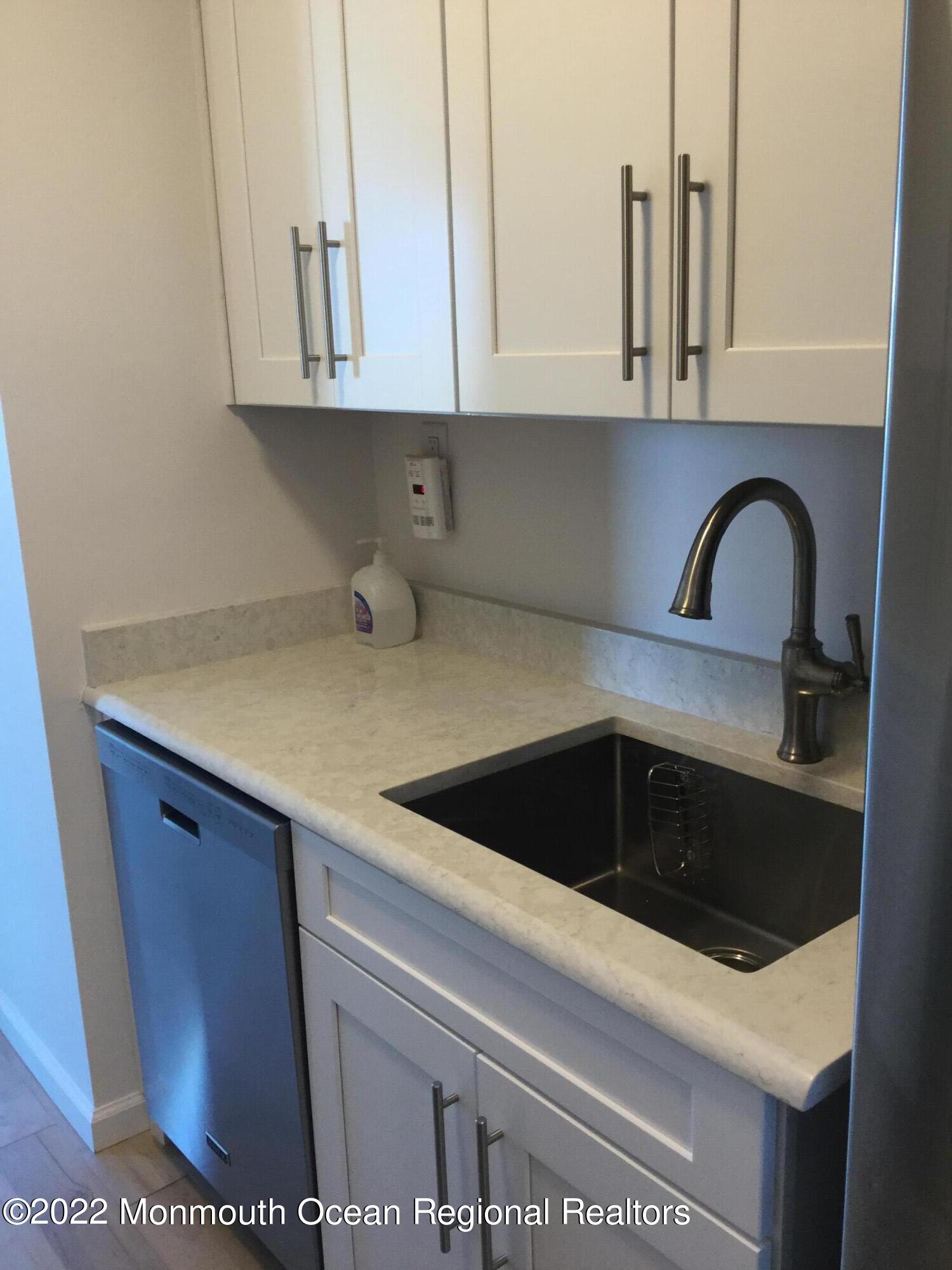 28 Riverside Avenue, Unit 6C Red Bank, NJ 07701 - Photo 7 of 26 a kitchen with a sink and cabinets
