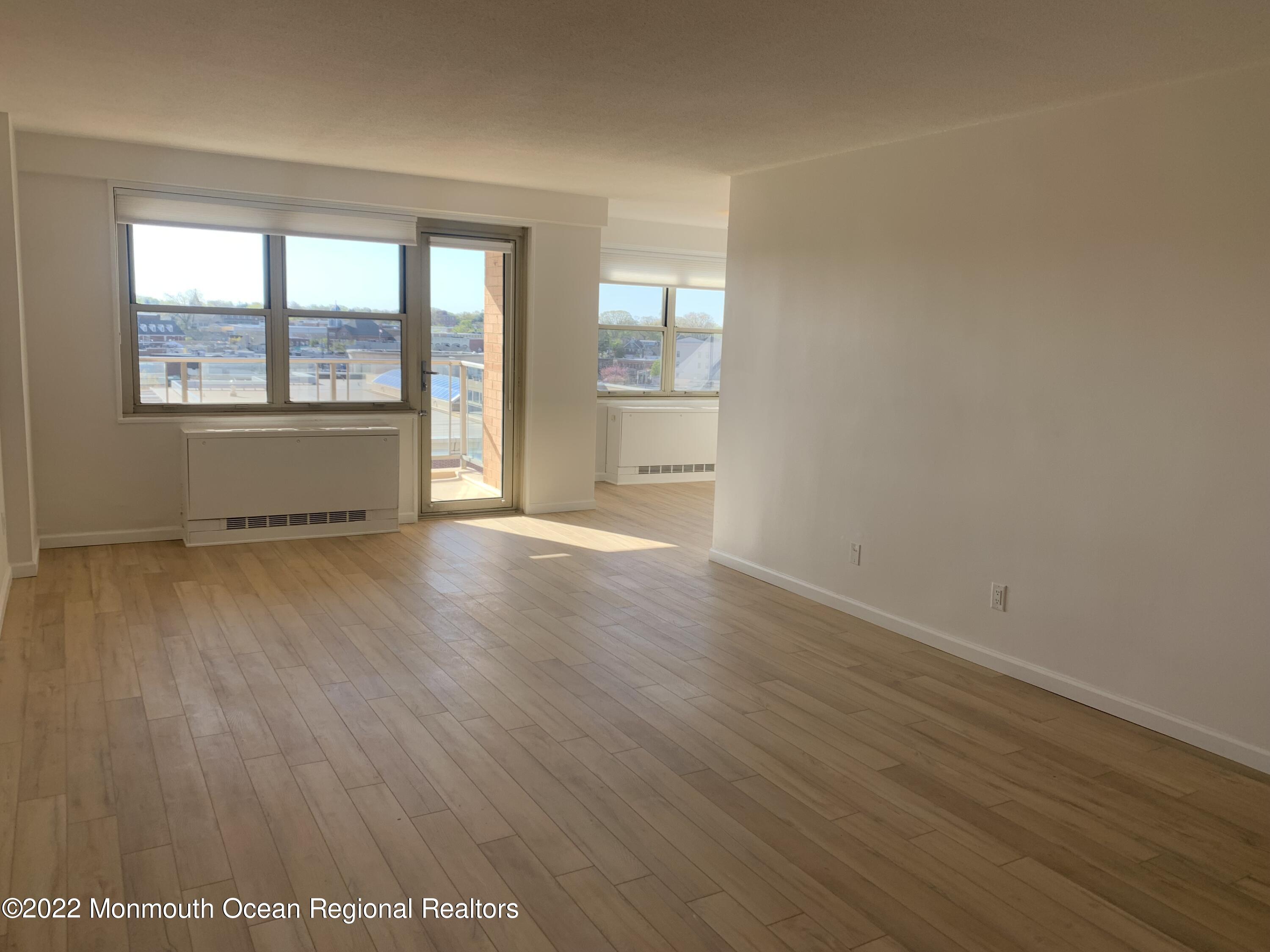 28 Riverside Avenue, Unit 6C Red Bank, NJ 07701 - Photo 10 of 26 an empty room with wooden floor and windows