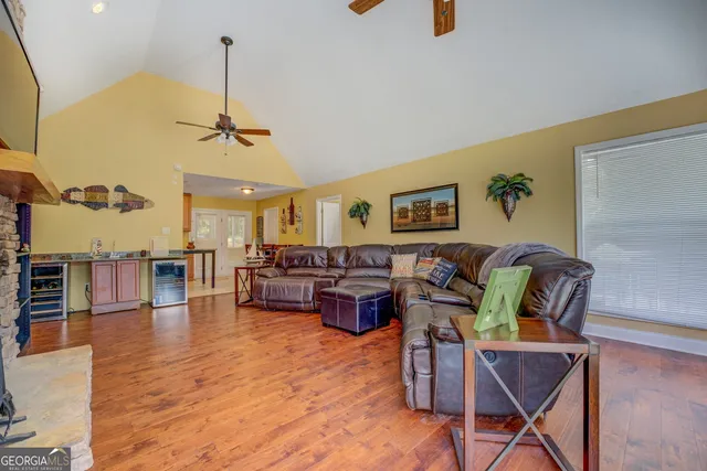 a living room with lots of furniture and wooden floor