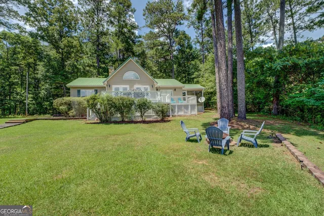 a view of a house with a yard and sitting area
