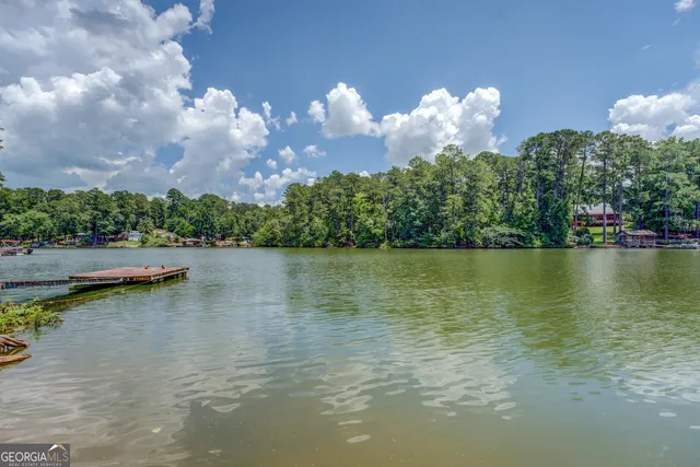 a view of a lake with houses in the back