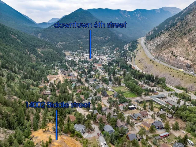 a view of a house with a yard and garden