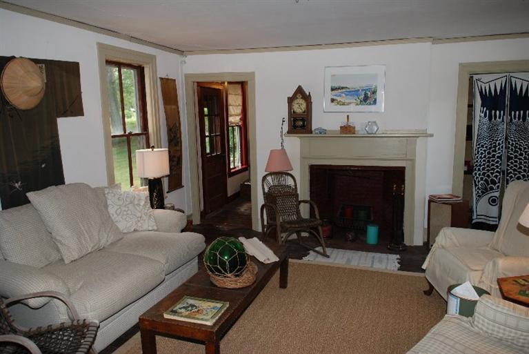 1276 County Road Cataumet, MA 02534 - Photo 5 of 15 a living room with furniture and a fireplace