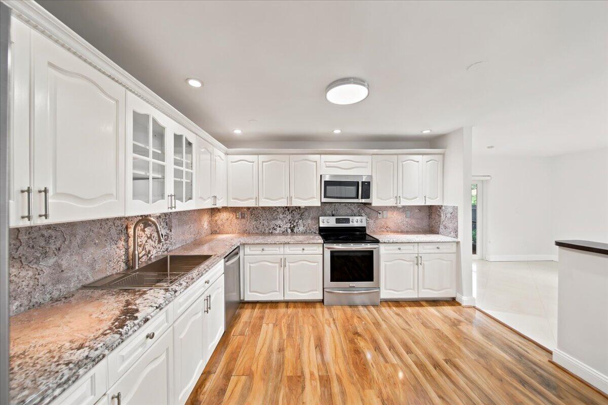 20009 Northwest 66th Place Hialeah, FL 33015 - Photo 15 of 33 a large kitchen with stainless steel appliances granite countertop a sink and cabinets