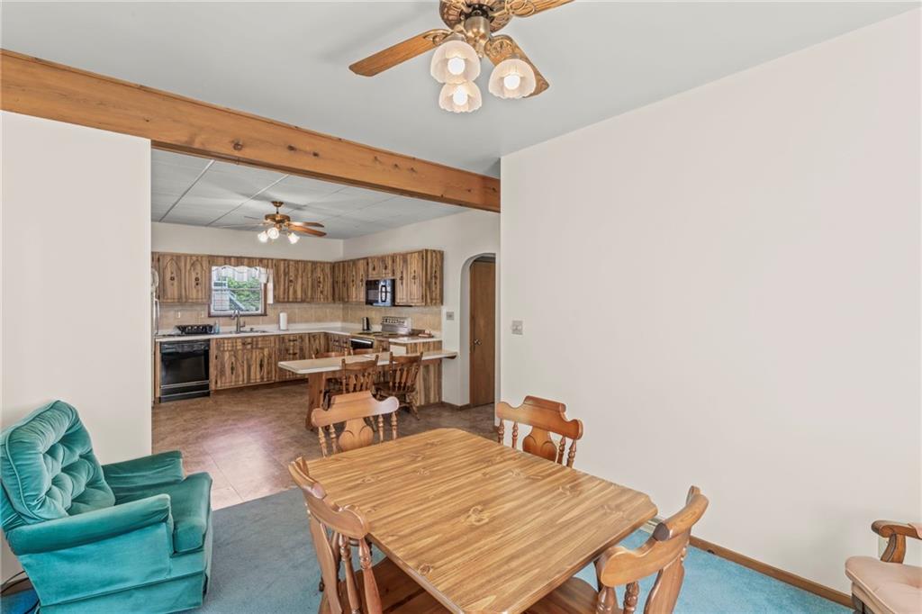 106 Donora Road Monongahela, PA 15063 - Photo 14 of 33 The Kitchen Flows Seamlessly Into The Dining Room For A Cohesive Space And A Stunning Overhead Wood Accent Beam Adds Character And Warmth, Making The Dining Area A Standout Feature Of The Home.