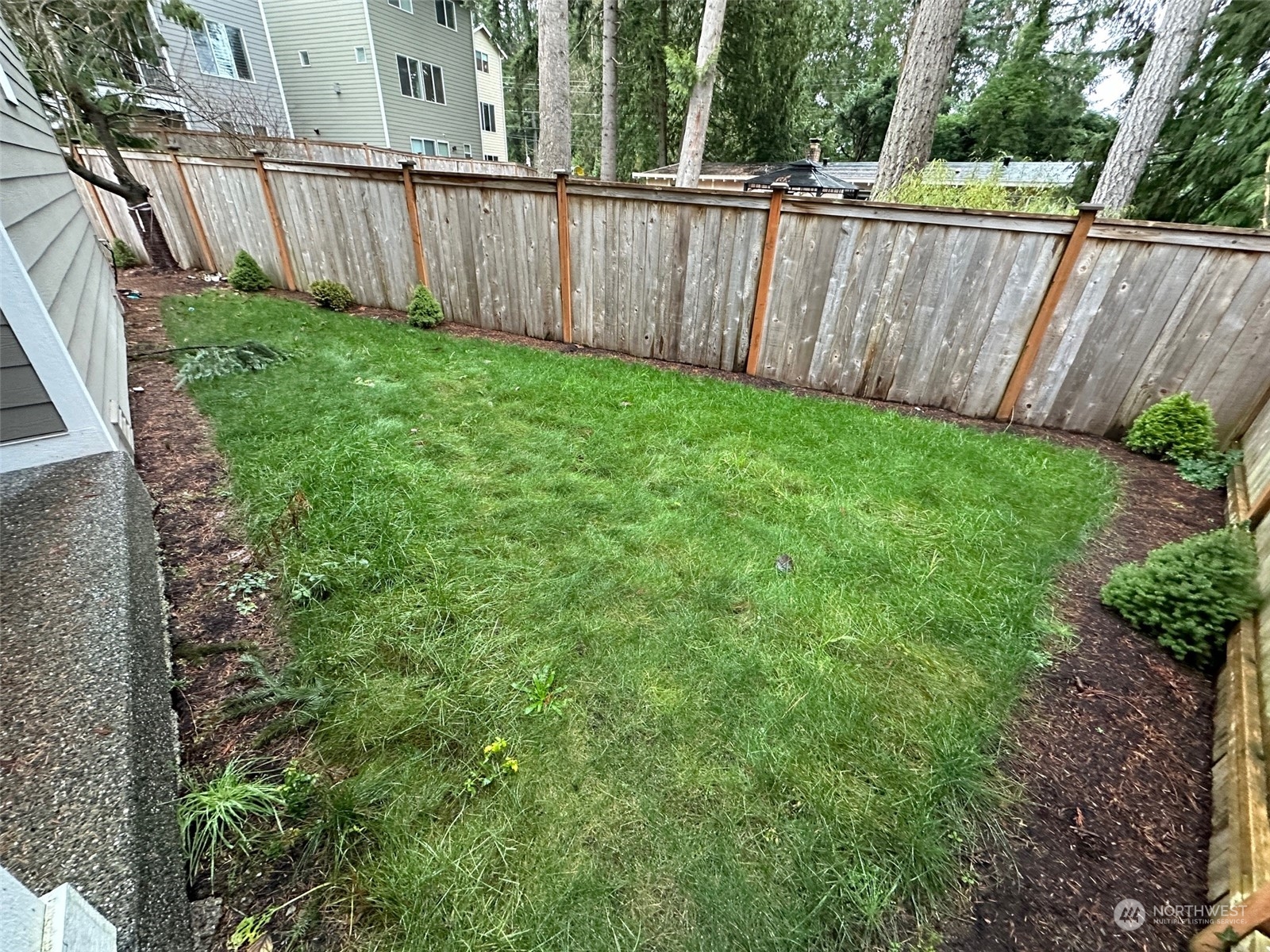 19721 Meridian Place West Bothell, WA 98012 - Photo 22 of 24 a view of a backyard with a wooden fence