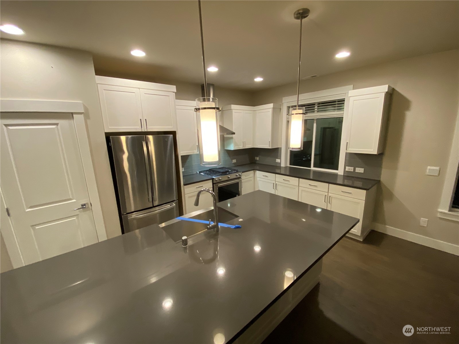 19721 Meridian Place West Bothell, WA 98012 - Photo 3 of 24 a kitchen with stainless steel appliances a refrigerator a sink a stove a microwave and island