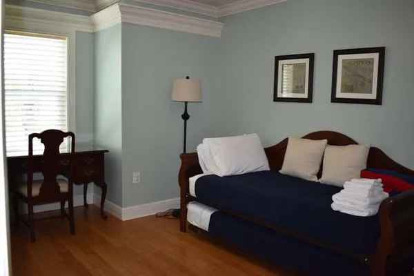 a living room with furniture lamp and window