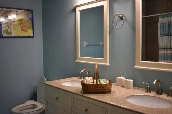 a bathroom with a toilet sink and mirror