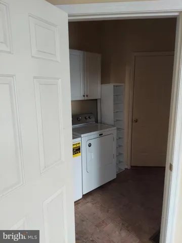 a utility room with cabinets washer and dryer
