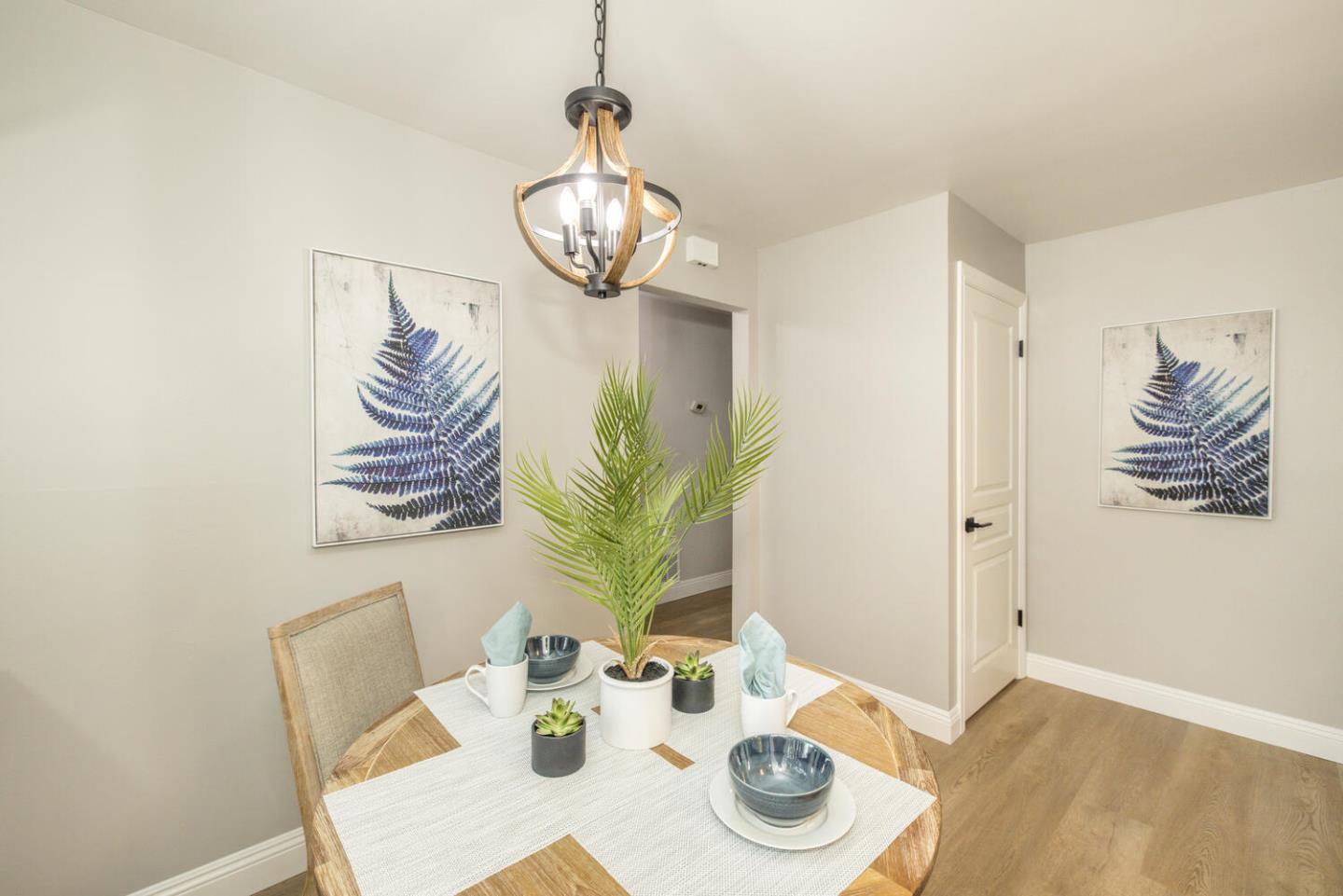 4027 Rector Common Fremont, CA 94538 - Photo 14 of 40 a view of a dining room with furniture a chandelier and wooden floor
