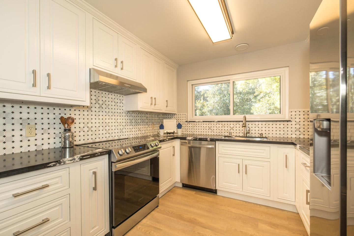 4027 Rector Common Fremont, CA 94538 - Photo 16 of 40 a kitchen with granite countertop stainless steel appliances a sink window and cabinets