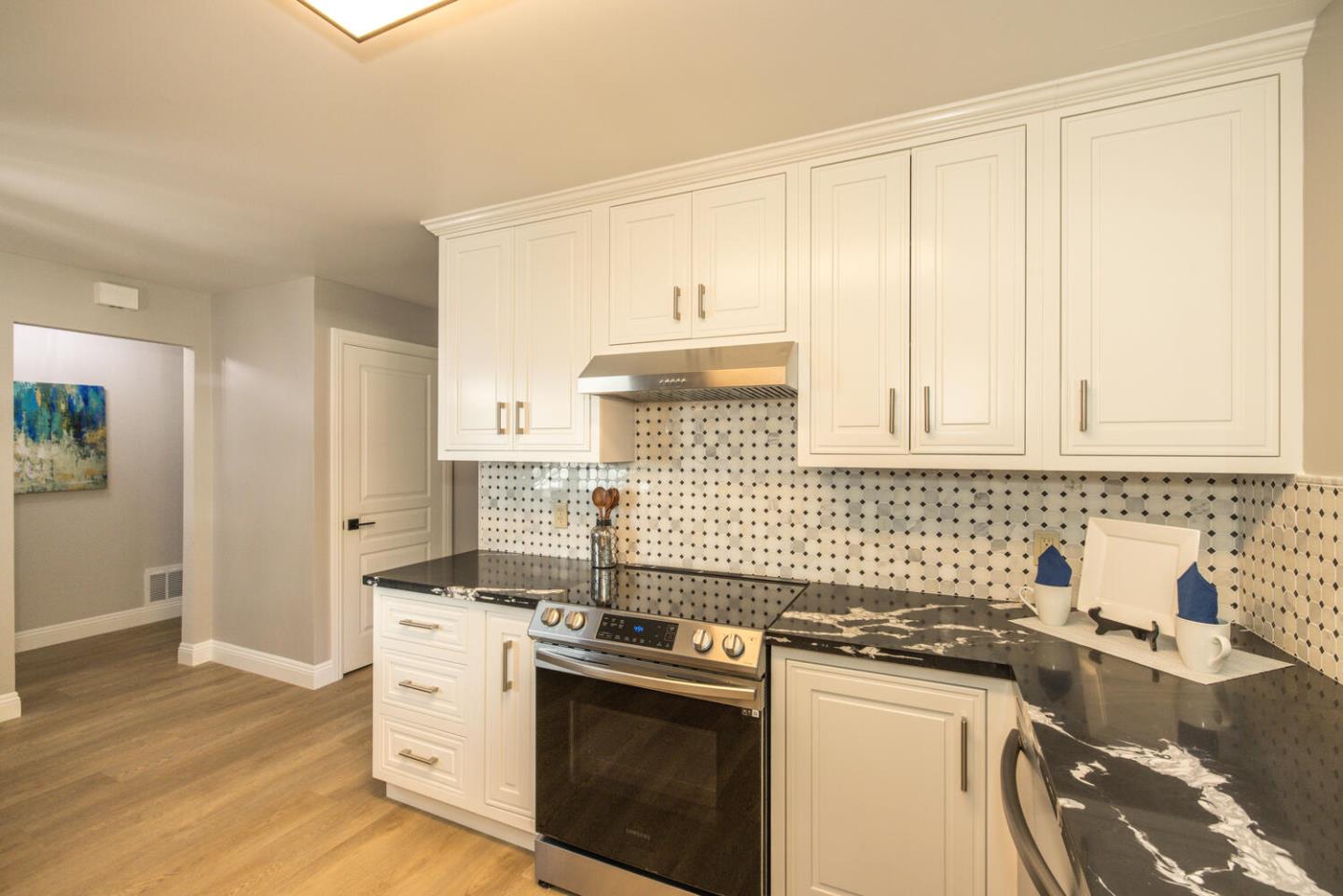4027 Rector Common Fremont, CA 94538 - Photo 17 of 40 a kitchen with stainless steel appliances granite countertop a sink stove and cabinets