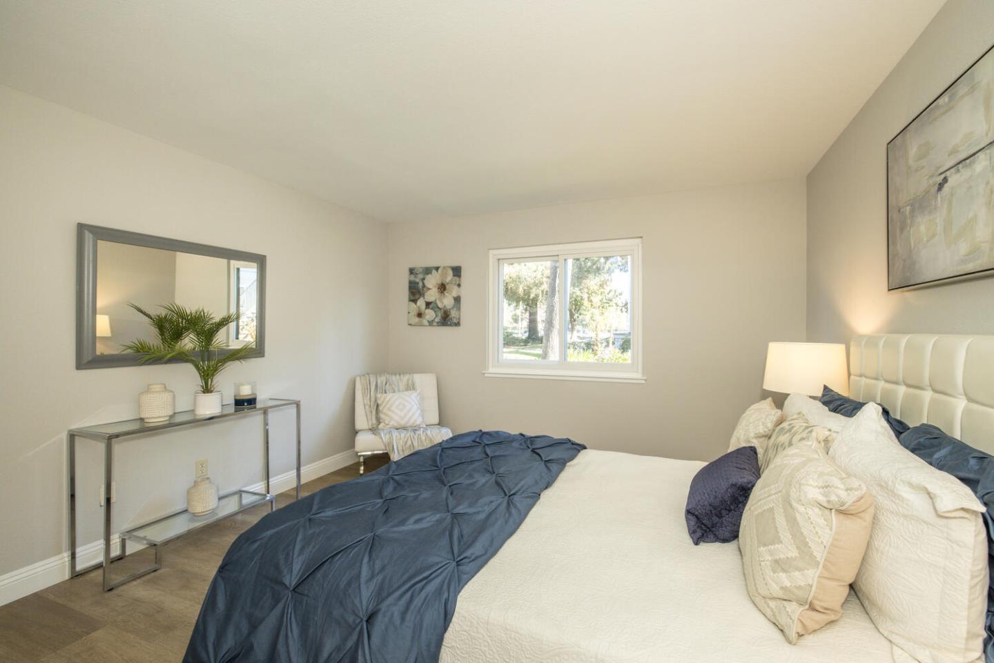 4027 Rector Common Fremont, CA 94538 - Photo 29 of 40 a bedroom with a bed and a chandelier