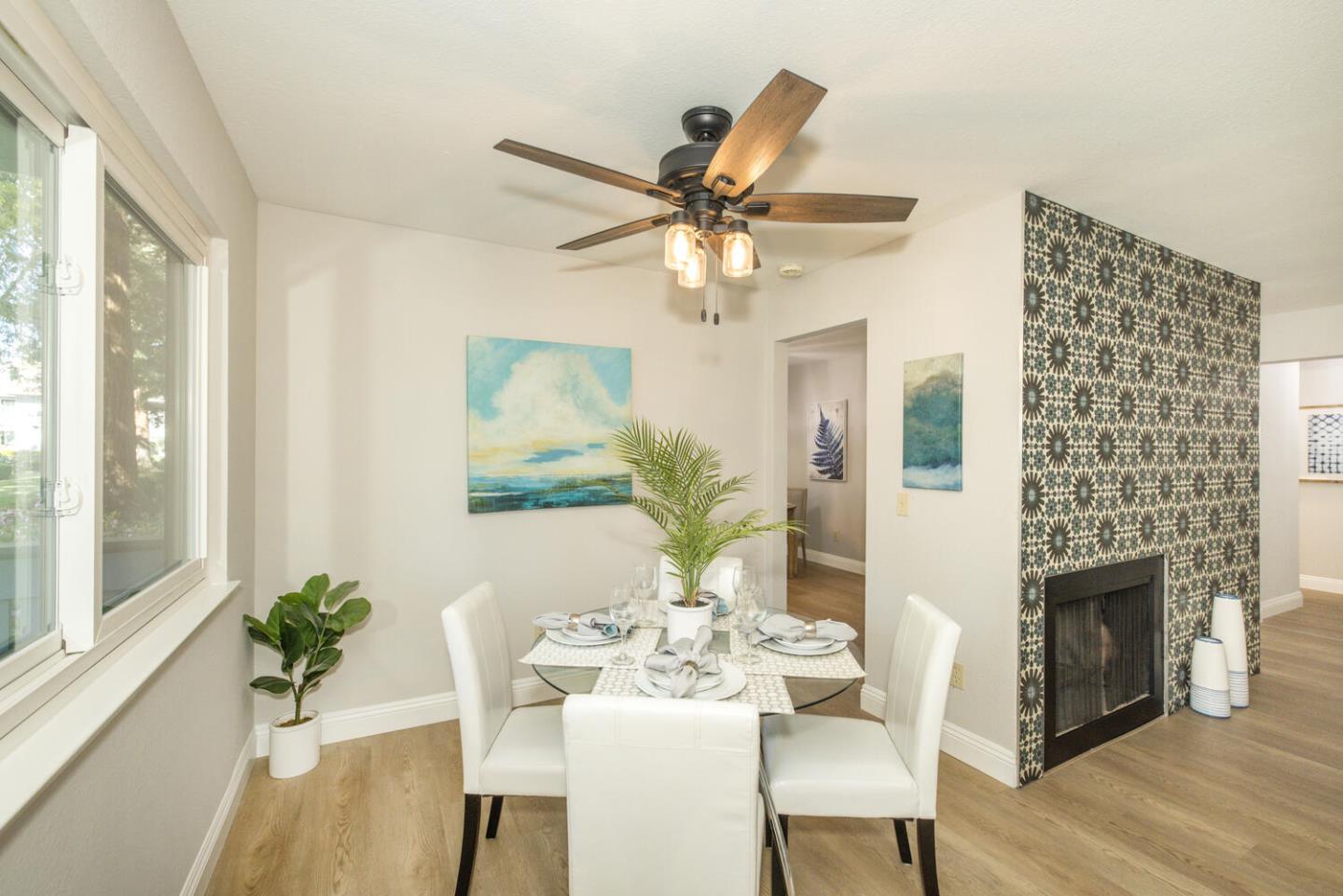 4027 Rector Common Fremont, CA 94538 - Photo 9 of 40 a dining room with furniture a fireplace and wooden floor