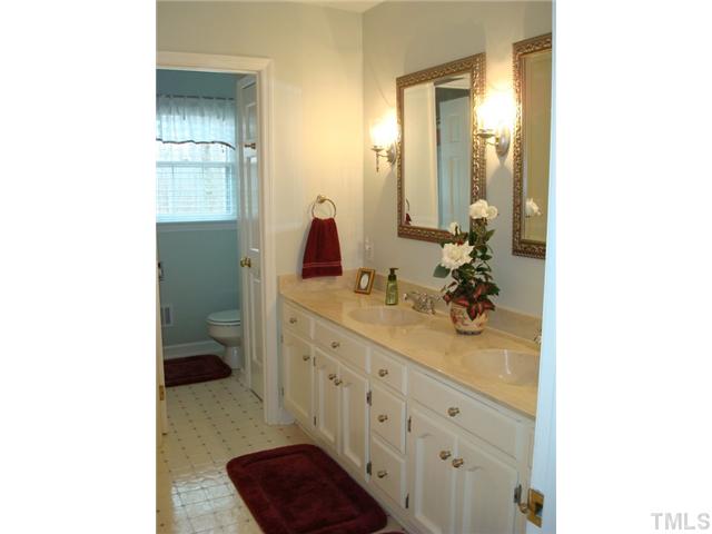 7905 Hollander Place Raleigh, NC 27606 - Photo 14 of 25 Large hall bath has double sinks and private tub/shower