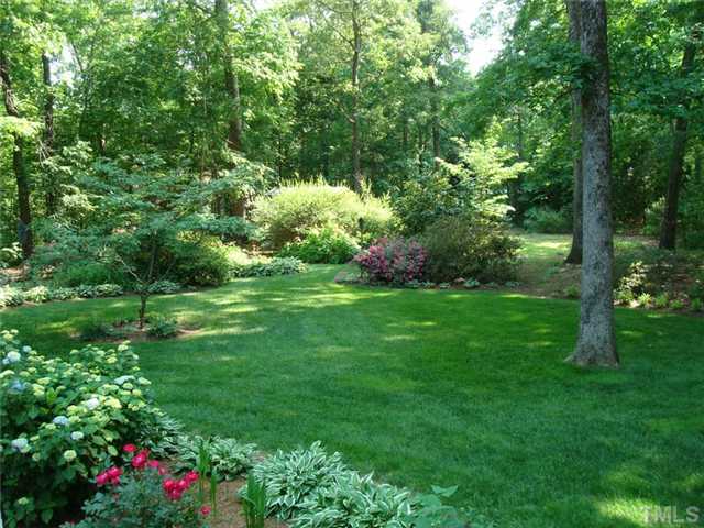 7905 Hollander Place Raleigh, NC 27606 - Photo 3 of 25 Beautiful private 1.6 acre lot is a gardeners paradise loaded with azaleas, dogwoods, camellias and many perennials.