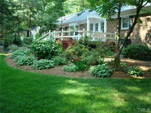 7905 Hollander Place Raleigh, NC 27606 - Photo 5 of 25 All brick exterior, large deck has built-in swing, roof is only 1 year old!
