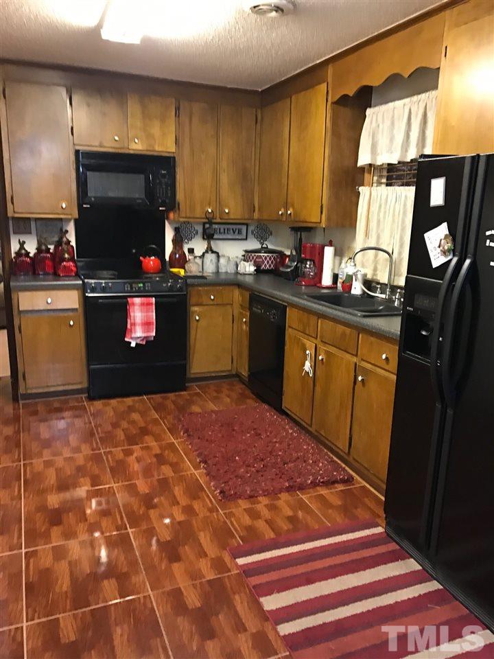 559 Clayton Road Durham, NC 27703 - Photo 14 of 15 a kitchen with a sink cabinets and appliances