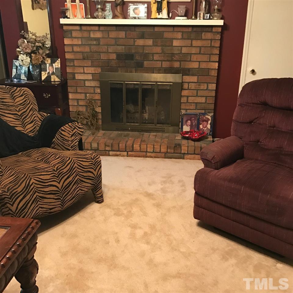 559 Clayton Road Durham, NC 27703 - Photo 5 of 15 a bedroom with a bed and a fireplace