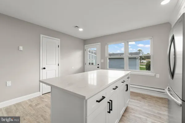 a view of kitchen with center island and wooden floor