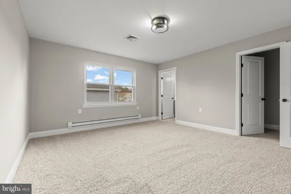 an empty room with a empty space and windows