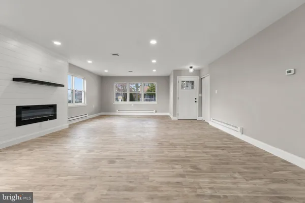 a view of empty room with a fireplace