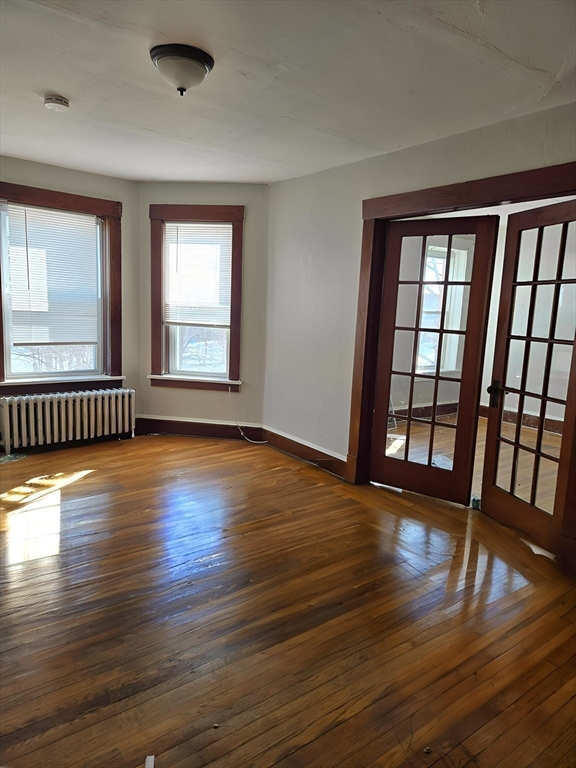 263 Elm Street, Unit 3L Holyoke, MA 01040 - Photo 2 of 12 a view of an empty room with wooden floor and a window