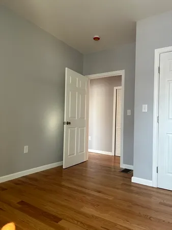 a view of wooden floor and windows in a room