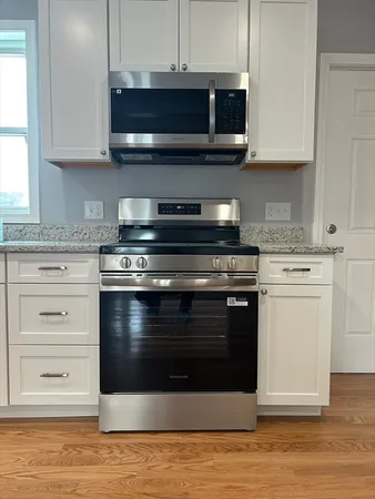 a kitchen with stainless steel appliances granite countertop a stove and a microwave