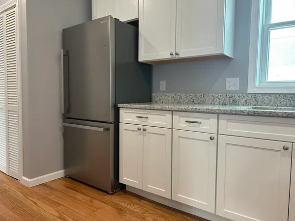 a kitchen with granite countertop cabinets and steel stainless steel appliances