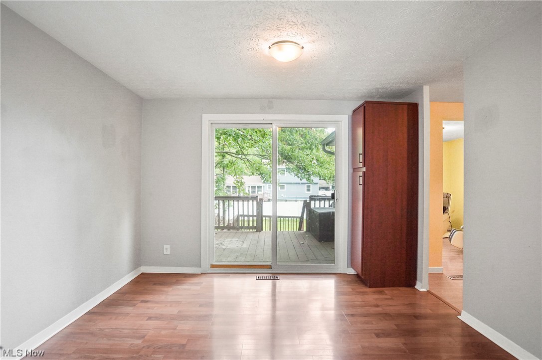 4252 Hile Road Stow, OH 44224 - Photo 11 of 31 Hardwood floored empty room with a textured ceiling